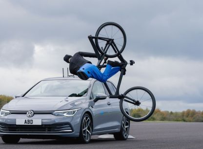 An AB Dynamics Volkswagen crashing into a testing dummy riding a bicycle