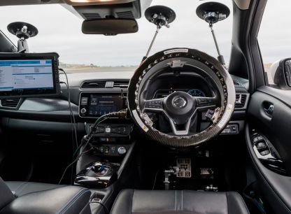 The steering wheel of a Nissan linked up to AB Dynamics hardware for testing
