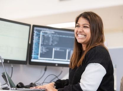 A smiling AB Dynamics colleague at a computer